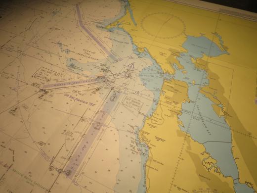 Planning for San Francisco. The chart of the harbour and Golden Gate Bridge. All happening on the navigation table on The Bridge.